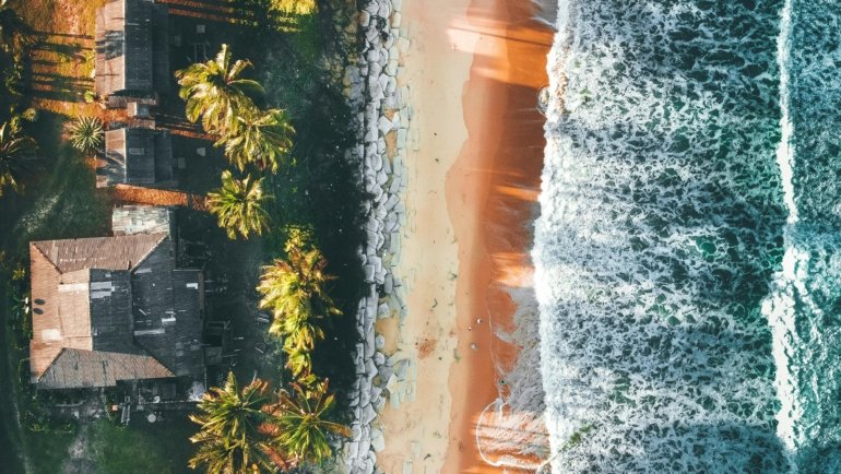 Stunning panoramic view of Malaysia's diverse beauty, featuring a sunny tropical beach, lush green rainforest, and a modern city skyline, illustrating the best time to travel to Malaysia for an ideal holiday.