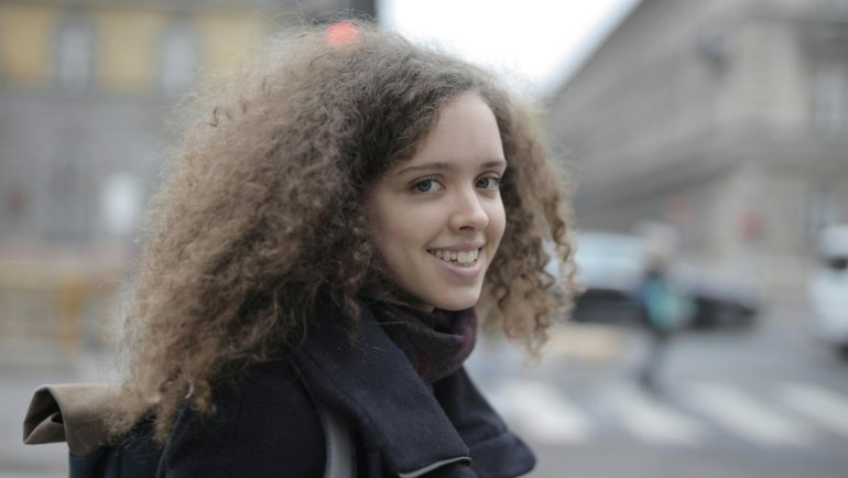 A person confidently exploring a bustling urban environment while wearing a modern anti-theft crossbody bag, emphasizing secure travel and peace of mind against pickpockets and digital theft.