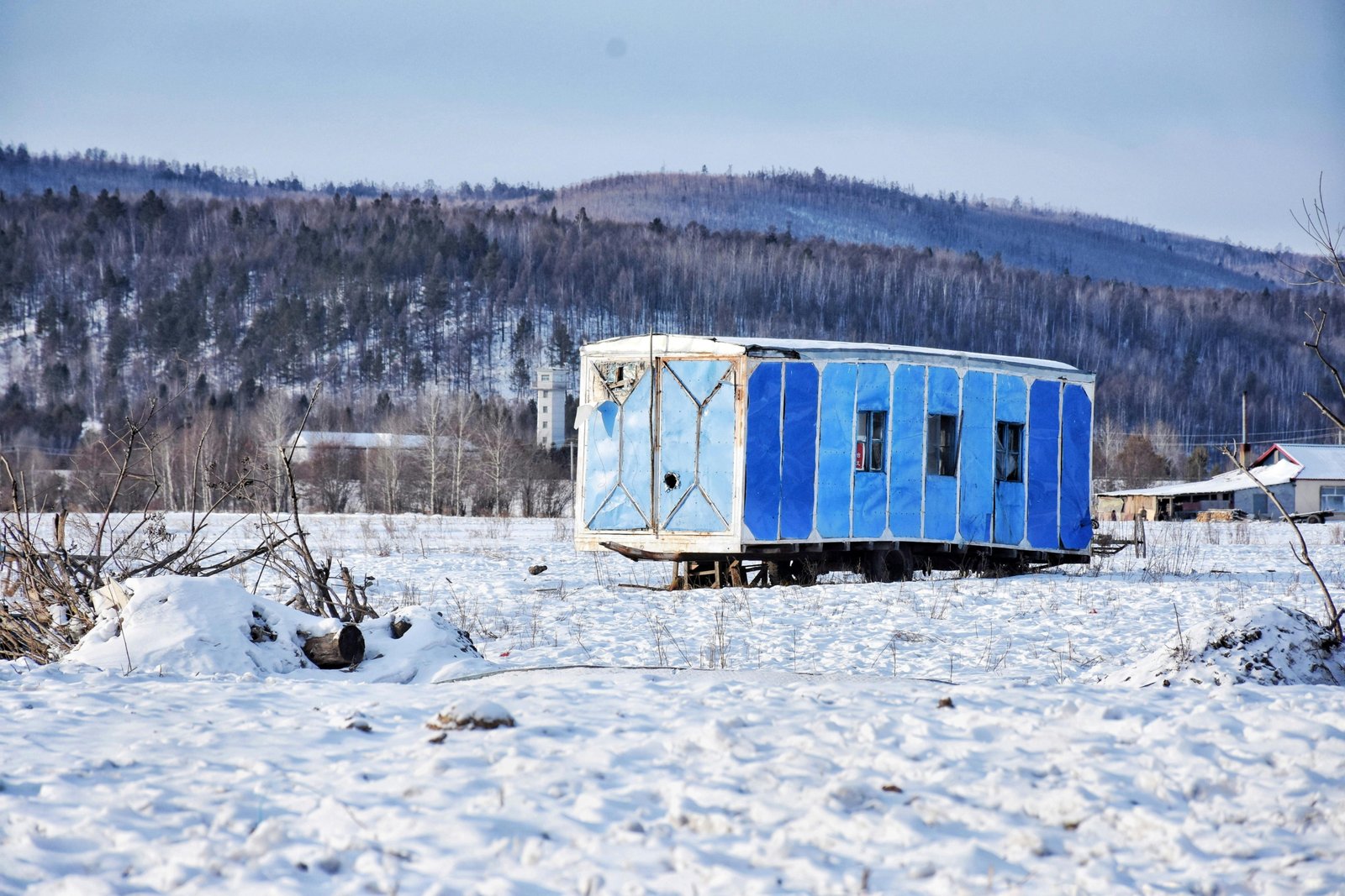 A 4 season travel trailer parked in a snowy mountain landscape, illustrating comfortable winter camping and year-round adventure capabilities of an all-season RV with enhanced insulation.