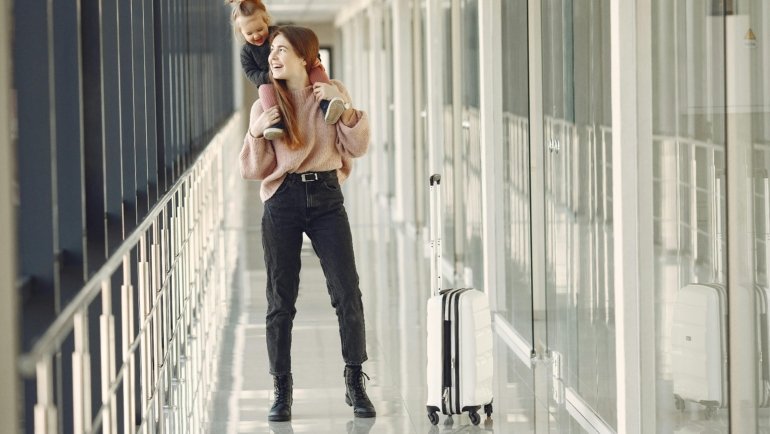 Colorful Minnie Mouse travel case at a lively airport, perfect Disney-themed hard-shell luggage for family vacations and kids' magical adventures.