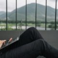 A person happily working on a laptop from a beautiful travel destination, embodying the digital nomad lifestyle and remote work opportunities to get paid to travel.
