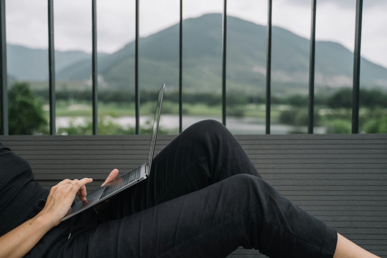 A person happily working on a laptop from a beautiful travel destination, embodying the digital nomad lifestyle and remote work opportunities to get paid to travel.