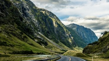Dramatic Norwegian fjord and towering mountain landscape, showcasing the breathtaking scenery for an unforgettable travel adventure.