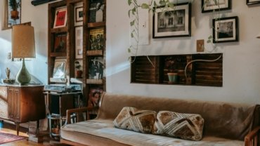 Vintage steamer travel trunk used as a coffee table in a stylish living room, showcasing its antique charm, leather details, and modern home decor versatility.