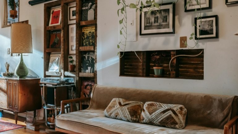 Vintage steamer travel trunk used as a coffee table in a stylish living room, showcasing its antique charm, leather details, and modern home decor versatility.