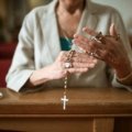Hands clasped in prayer for traveling, symbolizing peace, protection, and guidance for a safe and positive journey.