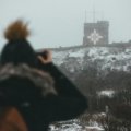 Happy traveler capturing a stunning vacation photo with a compact digital camera, illustrating the best compact camera for travel for superior image quality and portability.