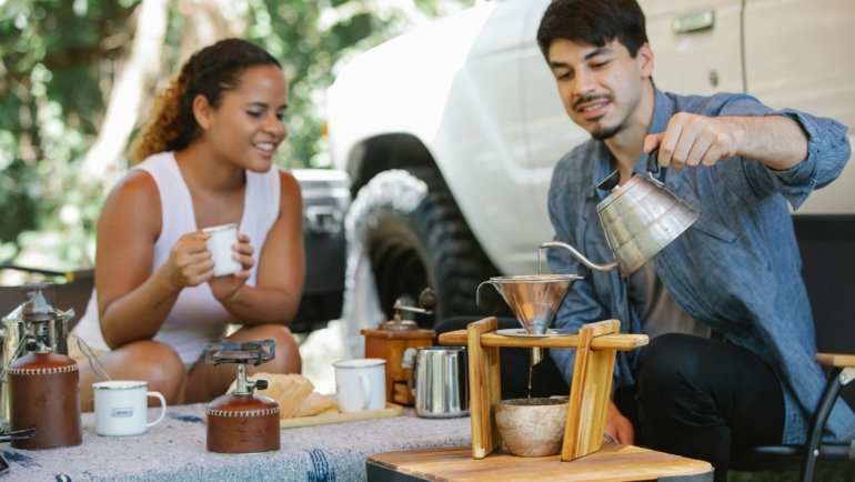 Portable travel backgammon set in use, illustrating two people enjoying the game on a trip, perfect for leisure and connection during any journey.