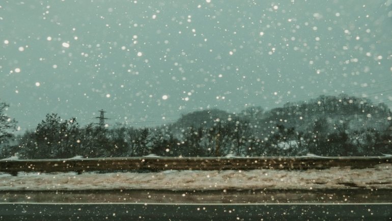 Empty snow-covered road during a WNY travel ban, illustrating severe winter weather, driving restrictions, and safety for Western New York residents.