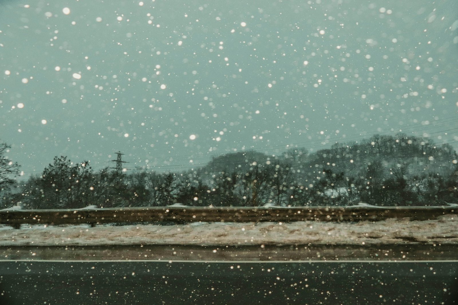 Empty snow-covered road during a WNY travel ban, illustrating severe winter weather, driving restrictions, and safety for Western New York residents.