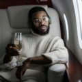 Soft, portable travel blanket providing warmth and comfort to a person relaxing on an airplane seat, emphasizing its benefits for long flights and travel.