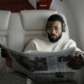 Person sleeping soundly with a comfortable ergonomic travel neck pillow on a plane, highlighting the importance of quality travel cushions for support and relaxation during long journeys.