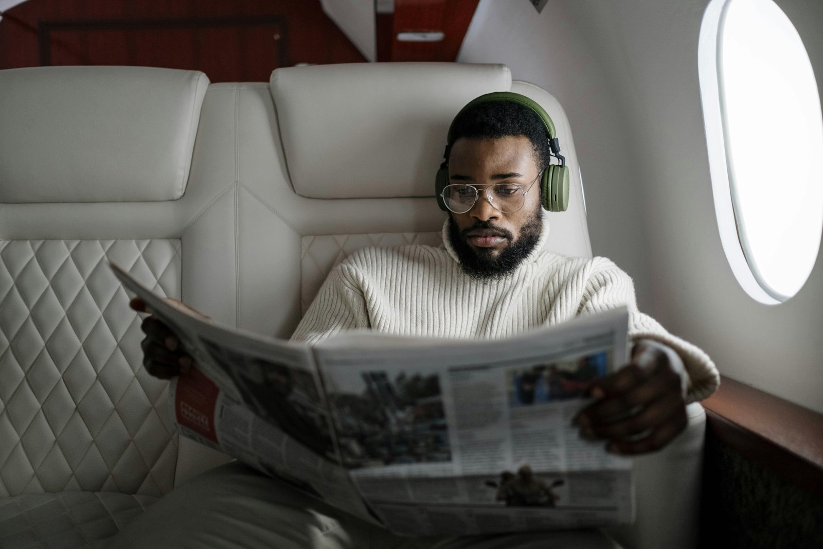 Person sleeping soundly with a comfortable ergonomic travel neck pillow on a plane, highlighting the importance of quality travel cushions for support and relaxation during long journeys.