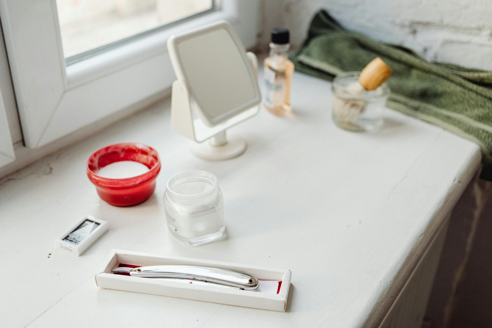 A stylish and organized men's travel kit (dopp kit) open, showcasing travel-sized grooming essentials like toothpaste, razor, and skincare products, ideal for efficient packing and fresh travel.