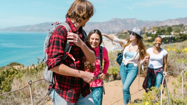 Glavs Travel: Happy diverse travelers on a personalized, unforgettable journey to a scenic global destination.