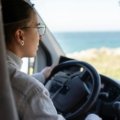 A versatile travel car, like an SUV or wagon, driving on a scenic open road during a multi-day road trip, symbolizing comfort, reliability, and adventure for optimal travel.