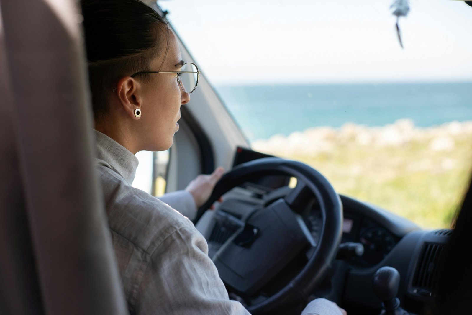 A versatile travel car, like an SUV or wagon, driving on a scenic open road during a multi-day road trip, symbolizing comfort, reliability, and adventure for optimal travel.