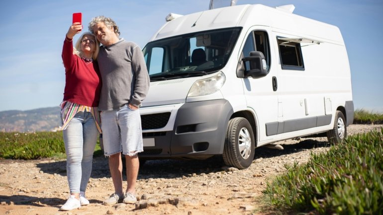 Happy family enjoying an RV road trip in a picturesque natural setting, highlighting the freedom, comfort, and convenience of recreational vehicle travel.
