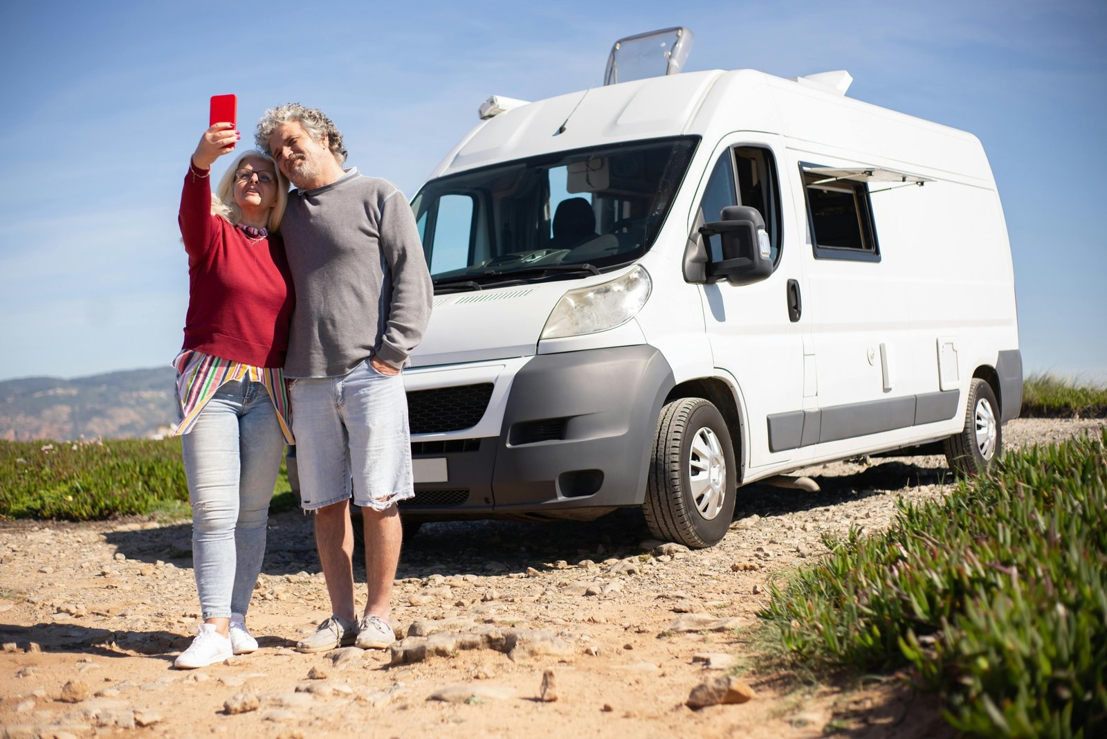 Happy family enjoying an RV road trip in a picturesque natural setting, highlighting the freedom, comfort, and convenience of recreational vehicle travel.