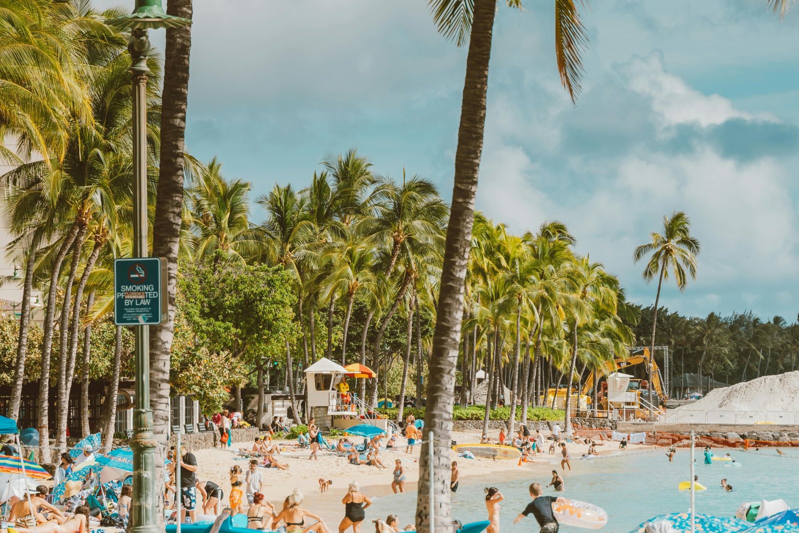 Pristine tropical beach with turquoise waters and palm trees, representing an ideal passport-free travel destination for US citizens to enjoy a relaxing vacation in US territories or on closed-loop cruises.