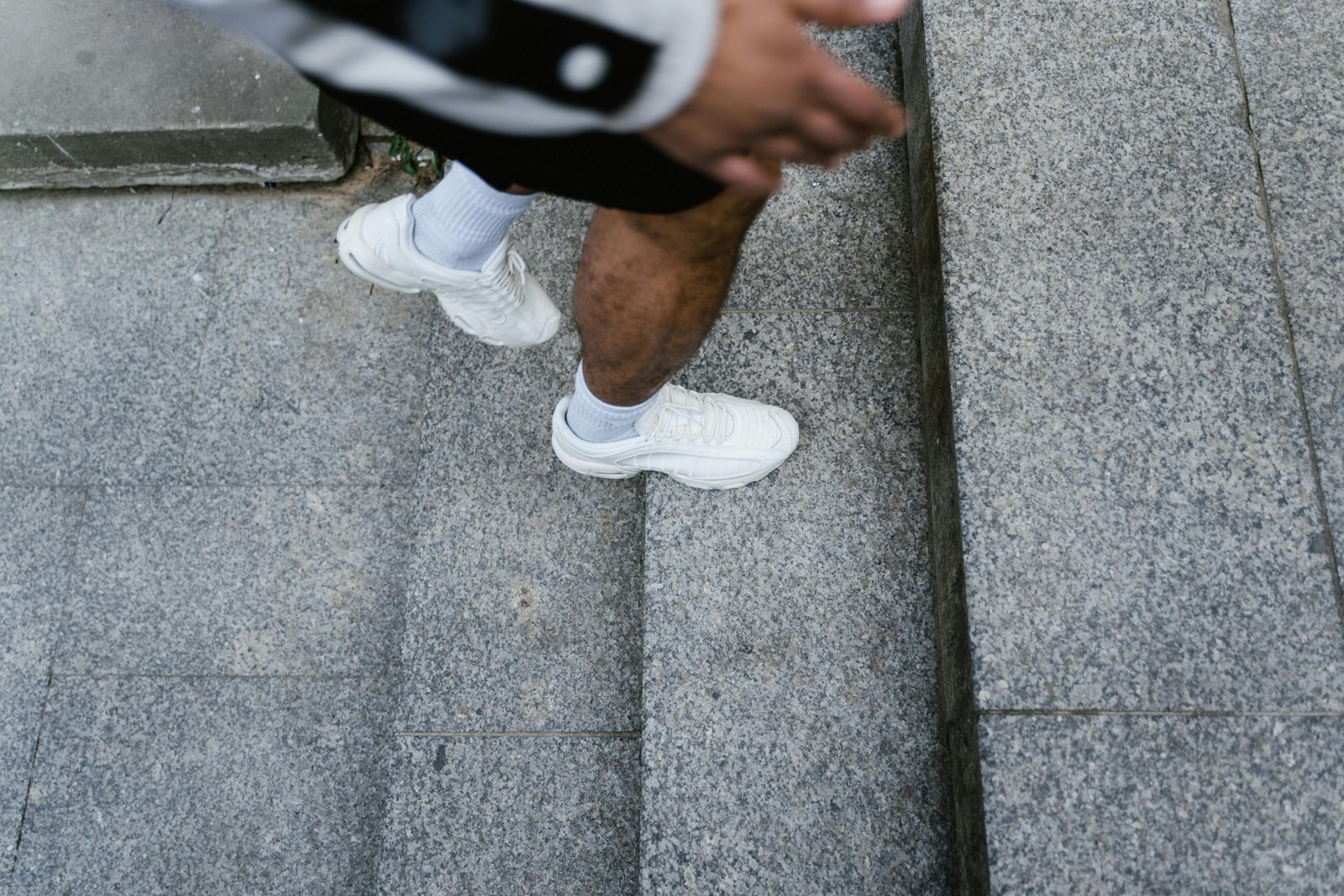 Person wearing comfortable and versatile travel shoes while walking and exploring a vibrant city or natural landscape, emphasizing readiness for adventure.