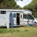 Modern lightweight travel trailer under 5000 lbs parked at a scenic campsite, symbolizing easy towing and comfortable camping adventures.