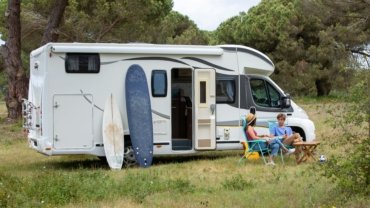 Modern lightweight travel trailer under 5000 lbs parked at a scenic campsite, symbolizing easy towing and comfortable camping adventures.