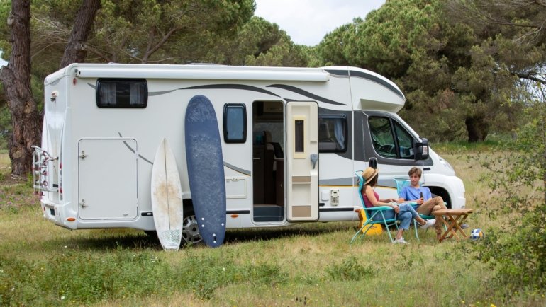 Modern lightweight travel trailer under 5000 lbs parked at a scenic campsite, symbolizing easy towing and comfortable camping adventures.