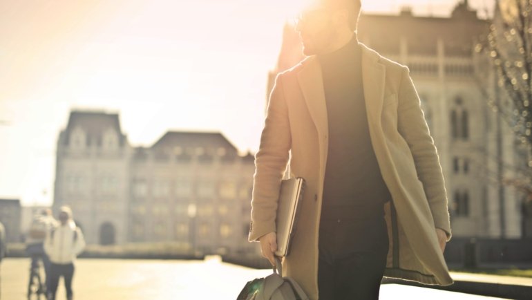 A smiling travel physical therapist looking confident, symbolizing a lucrative career path, professional growth, and the adventure of exploring new places while earning a high salary.