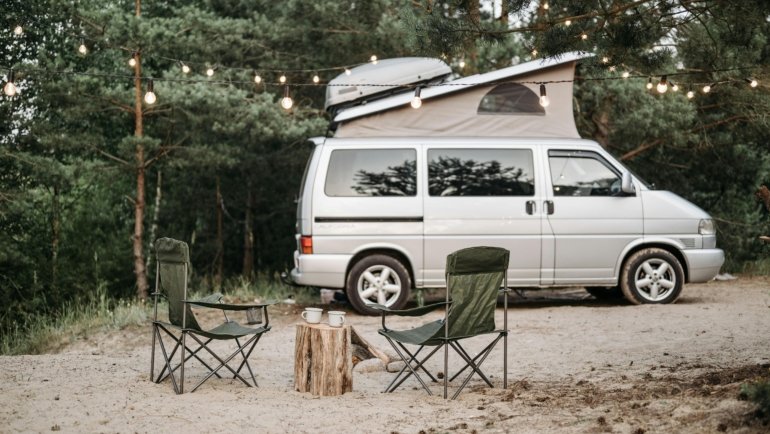 Travel Lite lightweight RV, a compact travel trailer or truck camper, parked in a scenic natural landscape, representing accessible and easy RV camping.