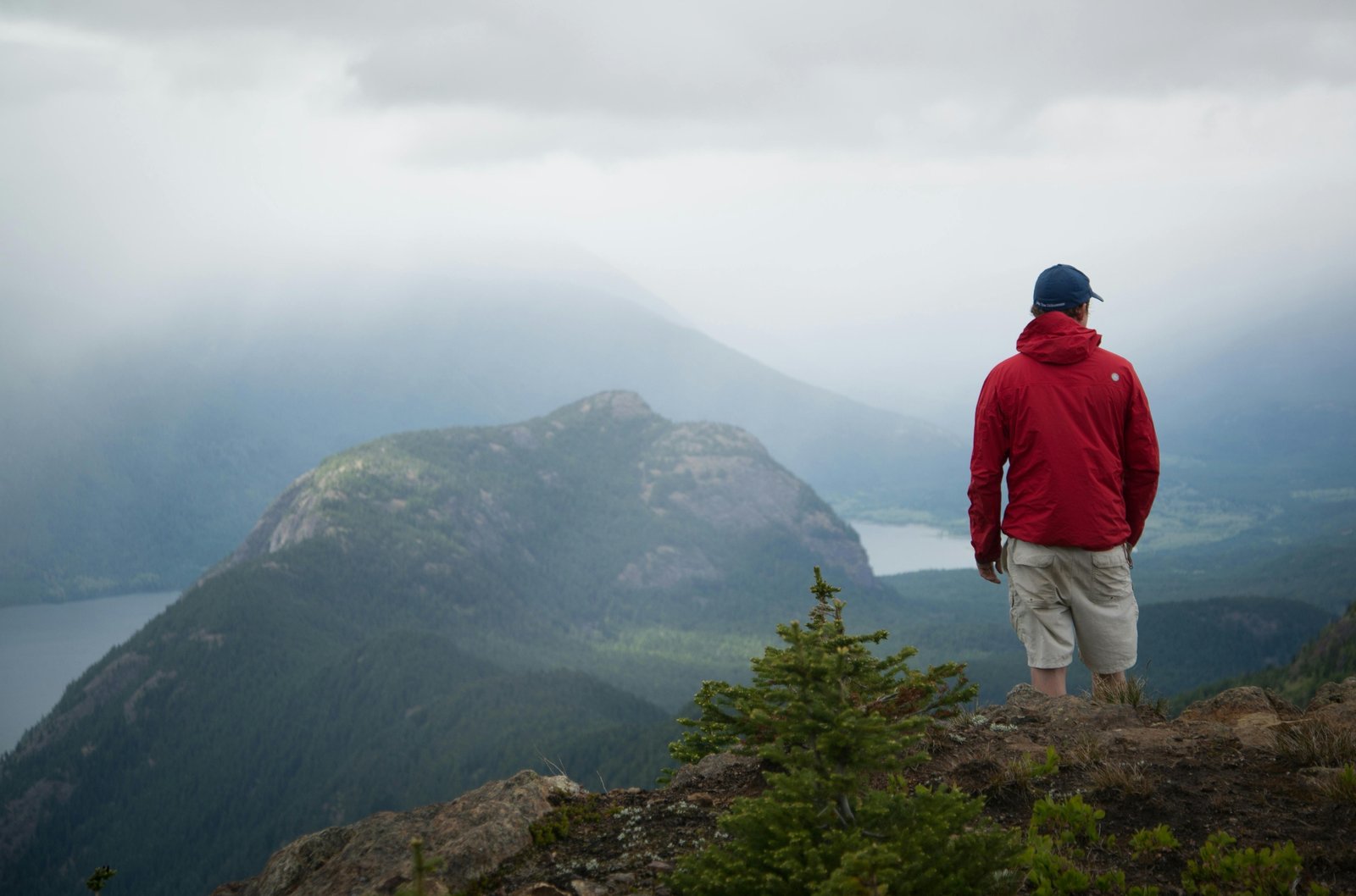 Adventurous traveler contemplating a vast, inspiring landscape, evoking wanderlust and the spirit of short travel quotes and personal journeys.