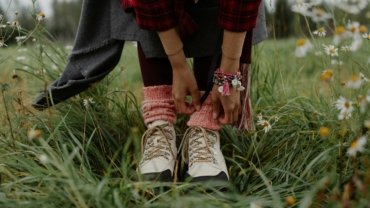 A female traveler confidently exploring a city street, showcasing comfortable and stylish travel footwear for women designed for long walks and adventure.
