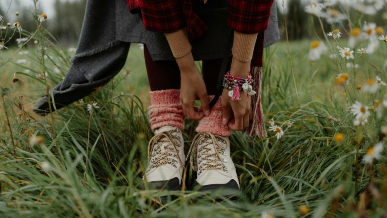 A female traveler confidently exploring a city street, showcasing comfortable and stylish travel footwear for women designed for long walks and adventure.