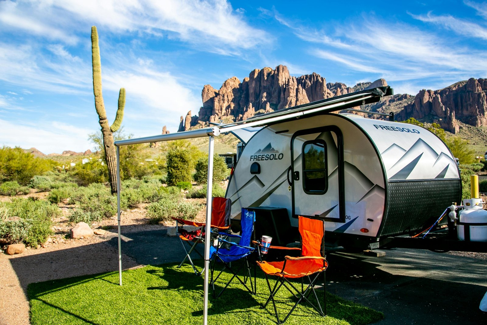 Lance travel trailer in a scenic natural landscape, symbolizing lightweight design, four-season comfort, and adventurous outdoor living.