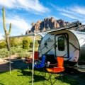 Modern Flagstaff travel trailer, a lightweight RV, parked in a picturesque national park setting, embodying comfortable camping, outdoor adventure, and freedom for explorers.