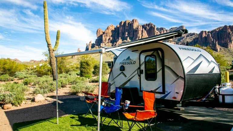 Modern Flagstaff travel trailer, a lightweight RV, parked in a picturesque national park setting, embodying comfortable camping, outdoor adventure, and freedom for explorers.