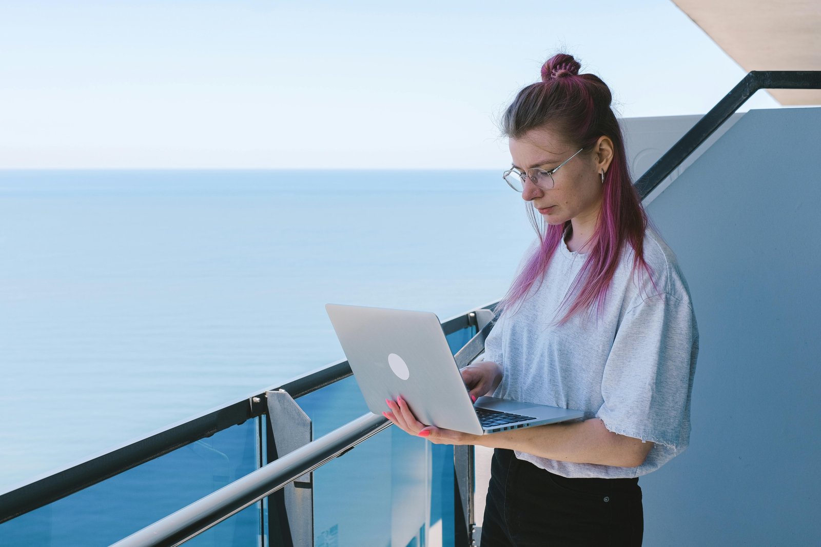 A happy digital nomad working on a laptop at a beautiful travel destination, embodying the flexible lifestyle of earning money remotely while exploring the world through online jobs and freelancing.