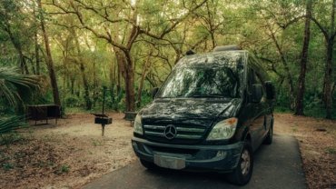 Custom Mercedes Sprinter travel van conversion for adventure and van life, parked in a scenic natural landscape, embodying freedom and off-grid living.