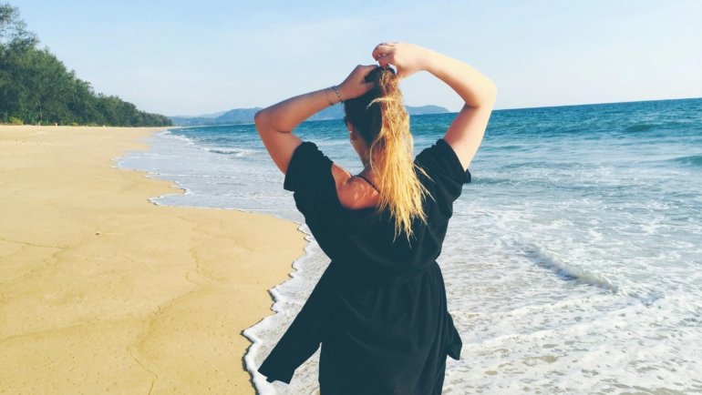 Person wearing comfortable and versatile travel sandals walking confidently on a scenic trail, highlighting durability and support for diverse travel adventures.