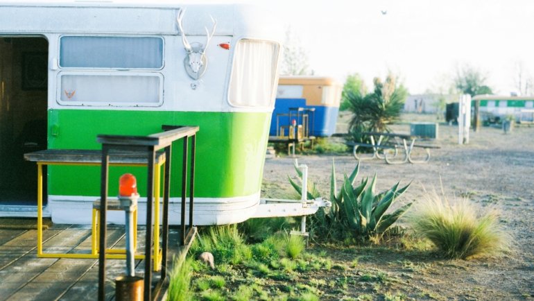 Vibrant retro style Riverside travel trailer in a picturesque outdoor camping setting, combining vintage design with modern comfort for adventure.