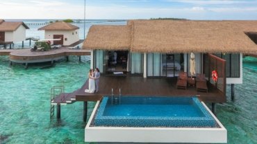 Happy couple relaxing at a luxurious resort during their stress-free honeymoon, planned by an expert travel agent.