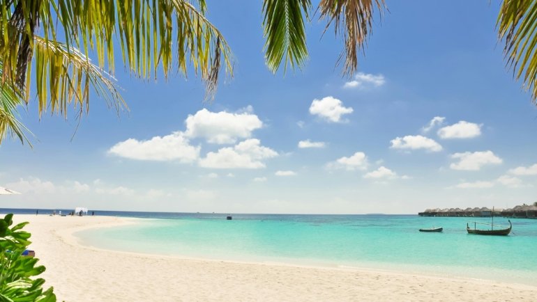 Idyllic Caribbean white sand beach with turquoise water under a clear sky, representing the perfect dream destination for travelers planning their ideal getaway.