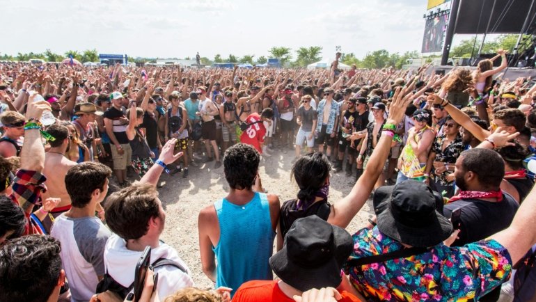 Passionate music fans on a road trip attending a lively Blues Traveler concert, illustrating the vibrant community of travelers.
