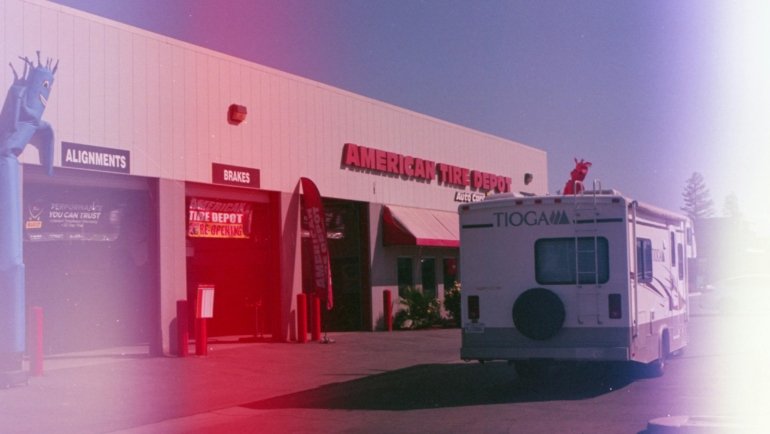 Hands replacing a part on an RV toilet in a travel trailer, illustrating DIY repair of common travel trailer toilet problems like leaks or running water using replacement parts.