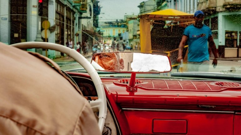 Iconic Cuba travel destinations image featuring classic American cars, vibrant colonial architecture in Old Havana, lush Viñales Valley mogotes, and pristine Varadero beaches, encapsulating the island's rich culture, history, and diverse experiences.