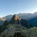 Panoramic view of Machu Picchu, a UNESCO World Heritage site, showcasing ancient Inca ruins amidst the majestic Peruvian Andes, representing incredible Peru travel destinations and cultural adventure.