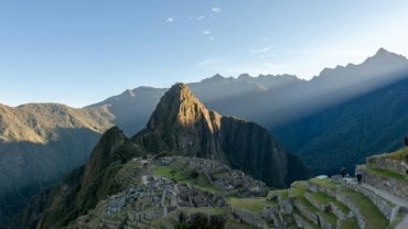 Panoramic view of Machu Picchu, a UNESCO World Heritage site, showcasing ancient Inca ruins amidst the majestic Peruvian Andes, representing incredible Peru travel destinations and cultural adventure.