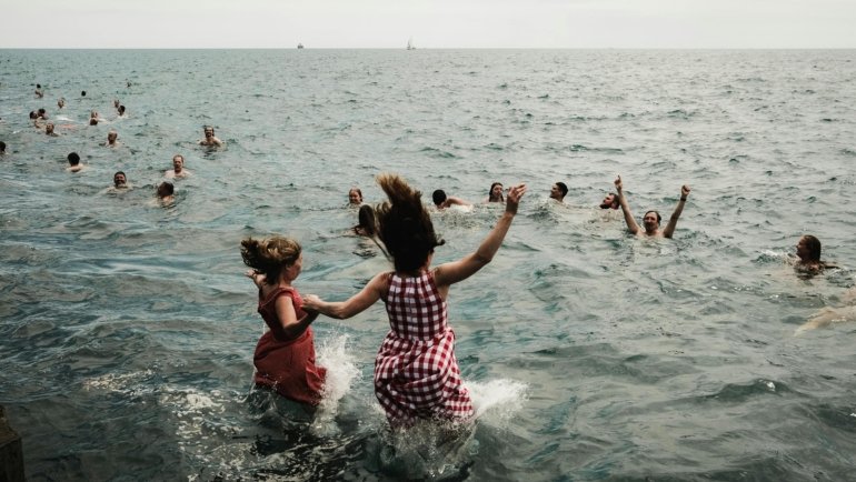 A joyful family, parents and children, exploring a scenic Midwest landscape, highlighting the region's appeal for diverse and affordable family travel.