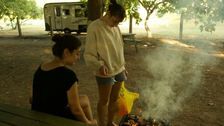 Modern Wildwood travel trailer parked in a scenic mountain campsite, symbolizing family adventure and comfortable RV camping.