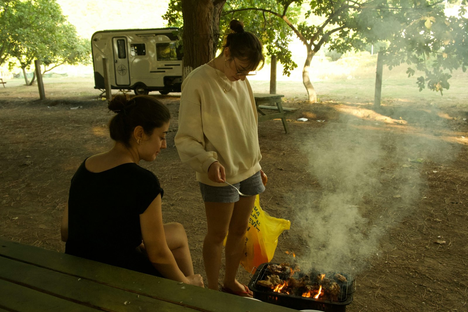 Modern Wildwood travel trailer parked in a scenic mountain campsite, symbolizing family adventure and comfortable RV camping.